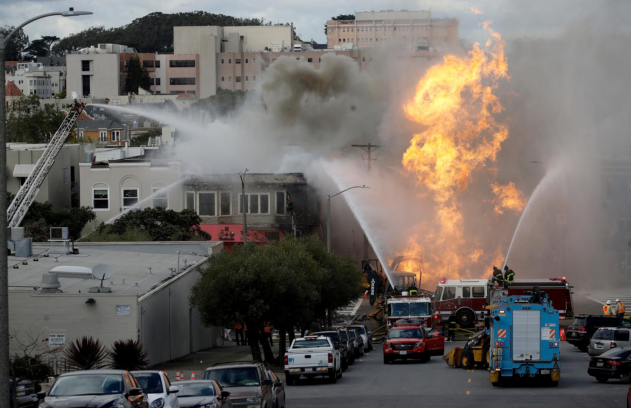san francisco firefighters battle a fire on geary boulevard in